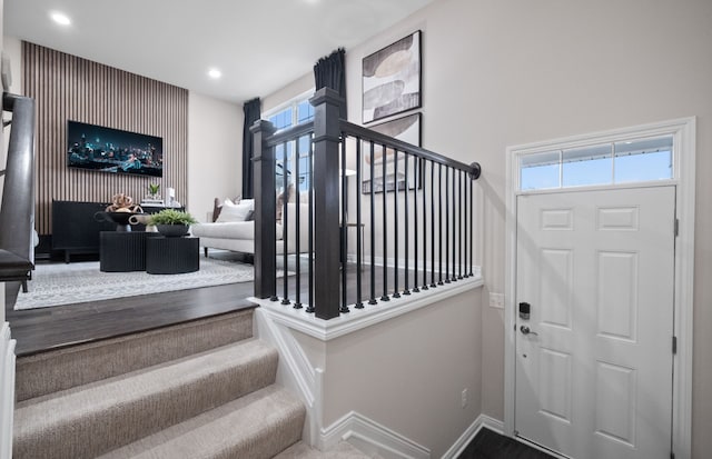 staircase featuring baseboards and recessed lighting