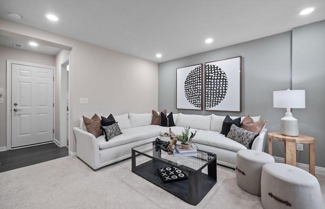 living area featuring carpet floors, baseboards, and recessed lighting