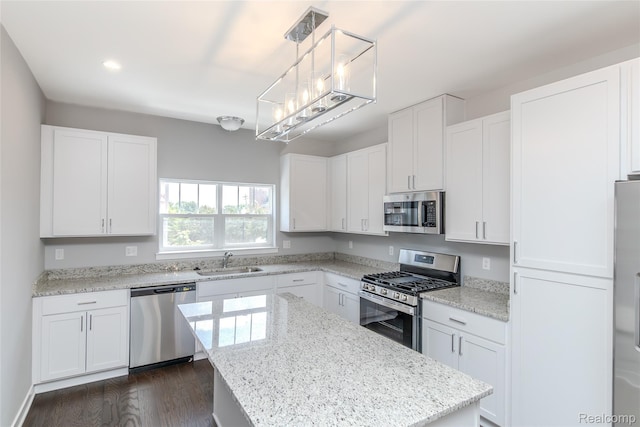 25549 Grandview Ln Unit 31, Novi, MI 48375 - kitchen featuring appliances with stainless steel finishes, white cabinets, dark wood finished floors, a kitchen island, and recessed lighting