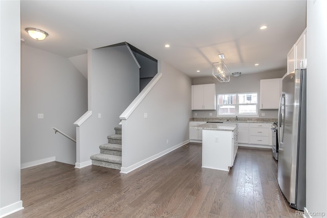 25549 Grandview Ln Unit 31, Novi, MI 48375 - kitchen featuring stainless steel appliances, a kitchen island, white cabinetry, dark wood finished floors, and recessed lighting