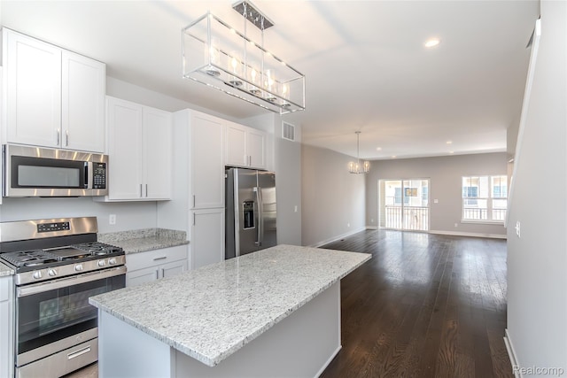 25549 Grandview Ln Unit 31, Novi, MI 48375 - kitchen with appliances with stainless steel finishes, a chandelier, a center island, open floor plan, and dark wood finished floors