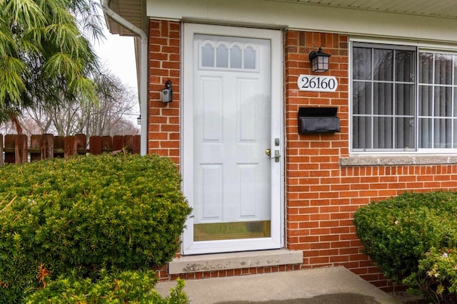 property entrance with brick siding