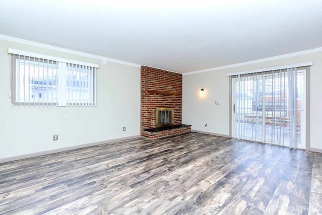 unfurnished living room with a fireplace, baseboards, ornamental molding, and wood finished floors