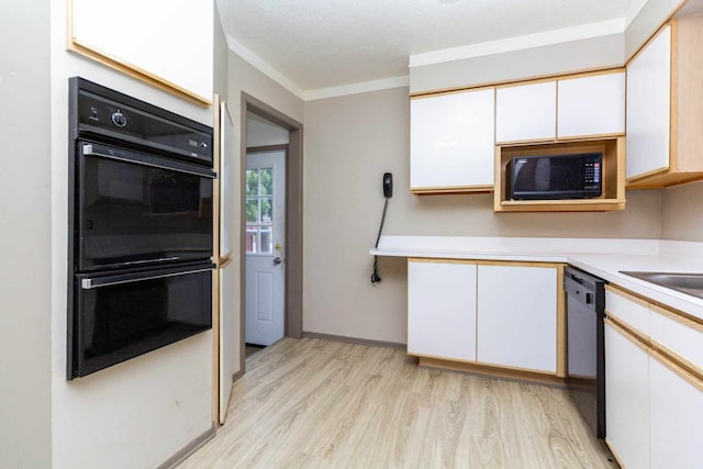 kitchen featuring white cabinets, light countertops, crown molding, black appliances, and light wood finished floors