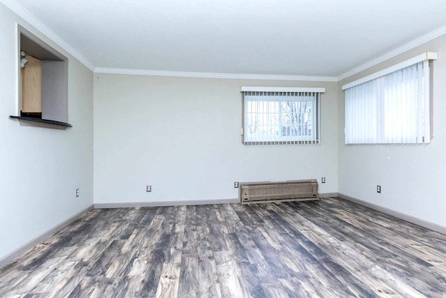 unfurnished room featuring crown molding, baseboards, and wood finished floors