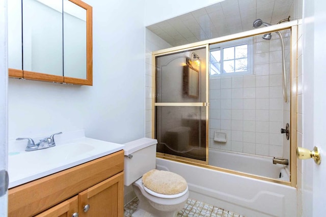 full bathroom featuring toilet, enclosed tub / shower combo, and vanity