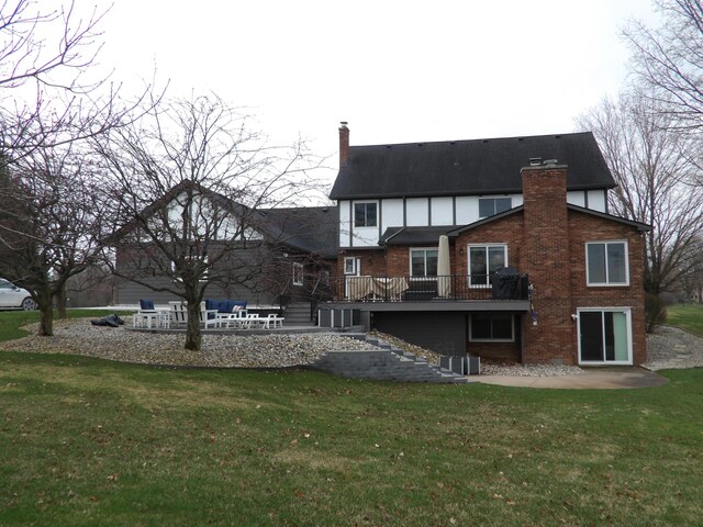 back of property with brick siding, a yard, a patio, and a chimney