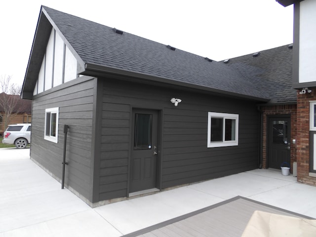 exterior space featuring a shingled roof