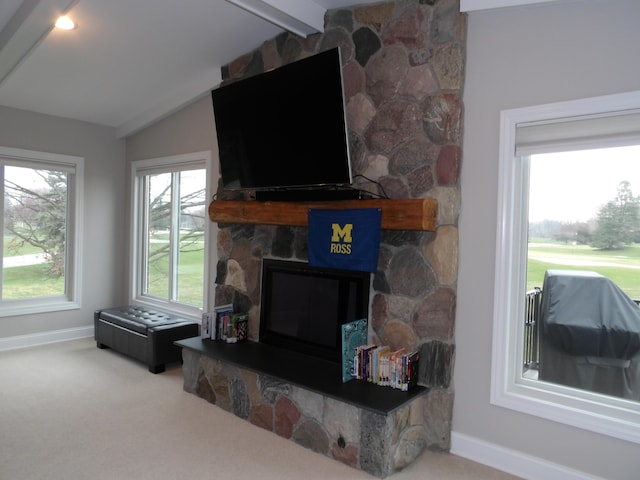 living area featuring baseboards, vaulted ceiling with beams, carpet flooring, and a fireplace