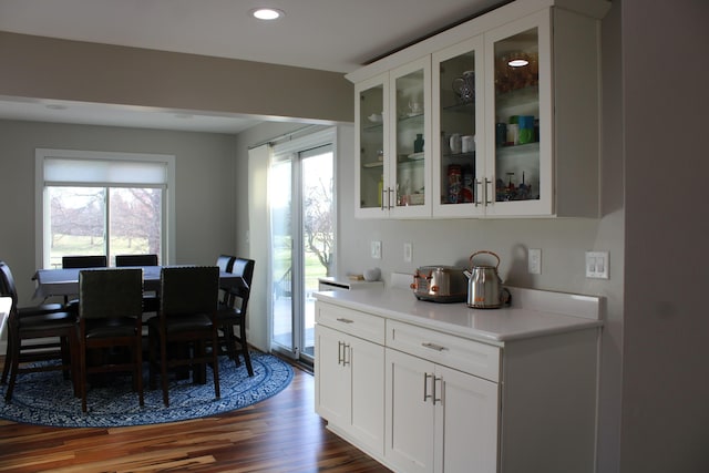 dining space with dark wood-type flooring and recessed lighting
