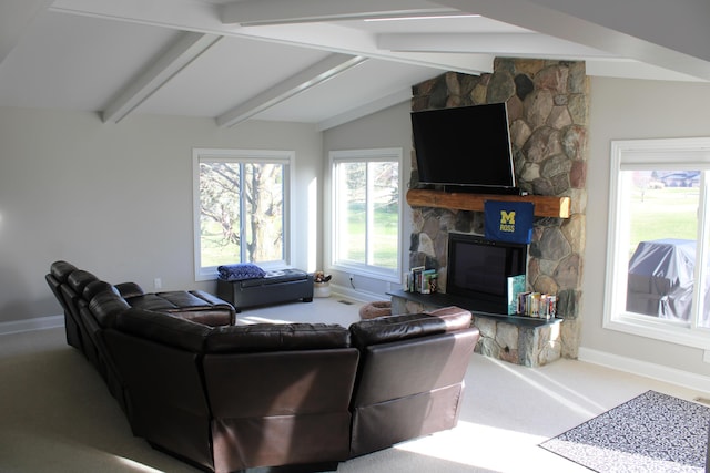 carpeted living area featuring a stone fireplace, baseboards, and vaulted ceiling with beams