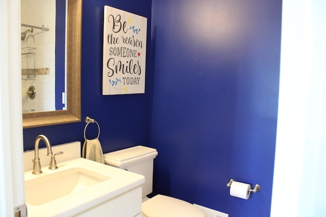 full bathroom with a shower, vanity, and toilet