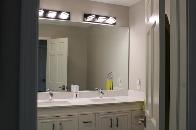 full bathroom featuring a sink and double vanity