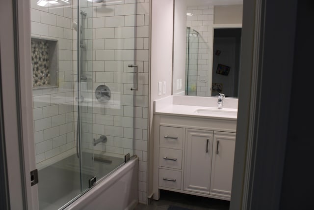 bathroom with vanity and enclosed tub / shower combo