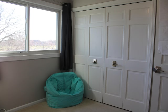 sitting room with baseboards and plenty of natural light