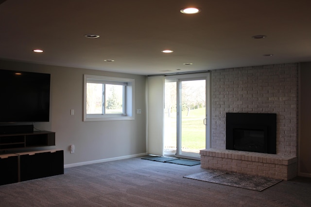 unfurnished living room featuring recessed lighting, a fireplace, baseboards, and carpet floors