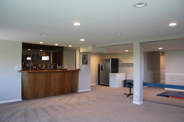 bar featuring a dry bar, recessed lighting, stainless steel fridge, and carpet