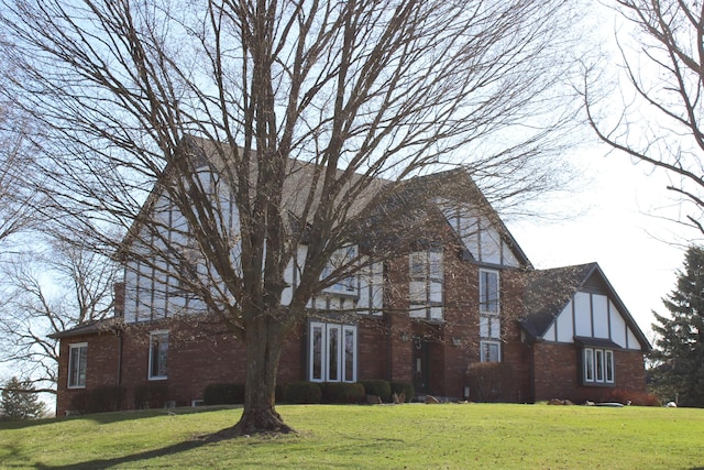 exterior space with a front lawn and brick siding