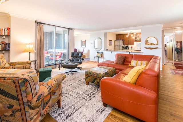 1050 Wall St Unit 3C, Ann Arbor, MI 48105 - living room featuring ornamental molding, light wood-type flooring, and a chandelier