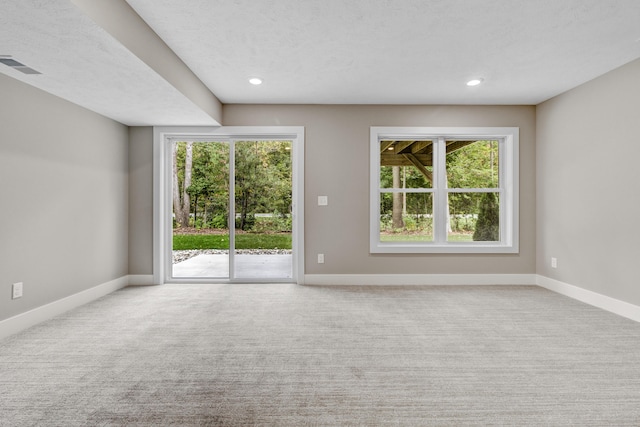 unfurnished living room with visible vents, baseboards, and carpet floors