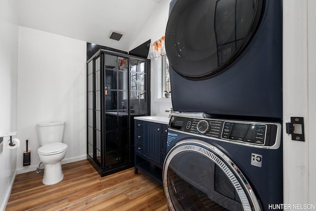 175 Cora Ave, Muskegon, MI 49445 - laundry area with baseboards, stacked washer and dryer, light wood-style flooring, laundry area, and a sink