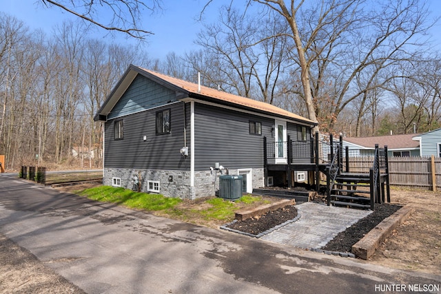 175 Cora Ave, Muskegon, MI 49445 - view of side of home with stairway, central AC unit, and fence
