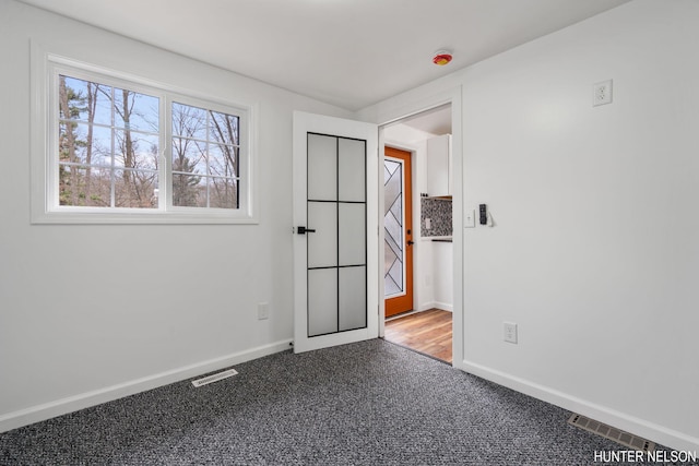 175 Cora Ave, Muskegon, MI 49445 - unfurnished room featuring visible vents, baseboards, and carpet floors