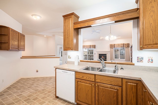 kitchen featuring dishwasher, brown cabinetry, a sink, and light countertops