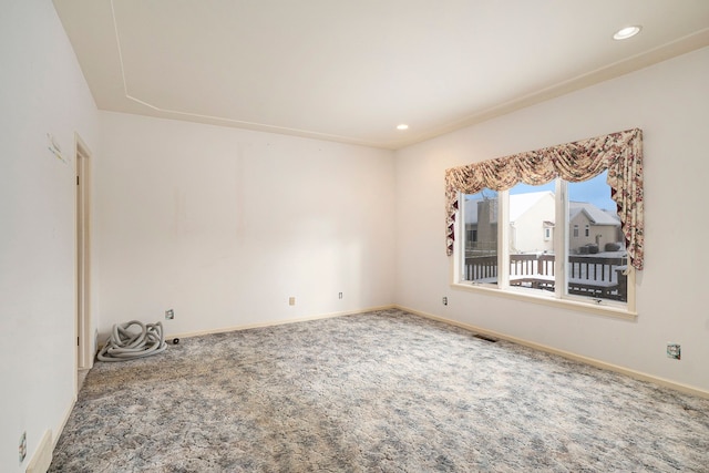 carpeted spare room featuring baseboards and recessed lighting