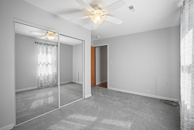 unfurnished bedroom with a ceiling fan, a closet, baseboards, carpet flooring, and visible vents