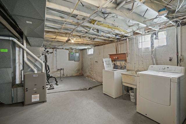 below grade area with independent washer and dryer, electric panel, heating unit, and a sink