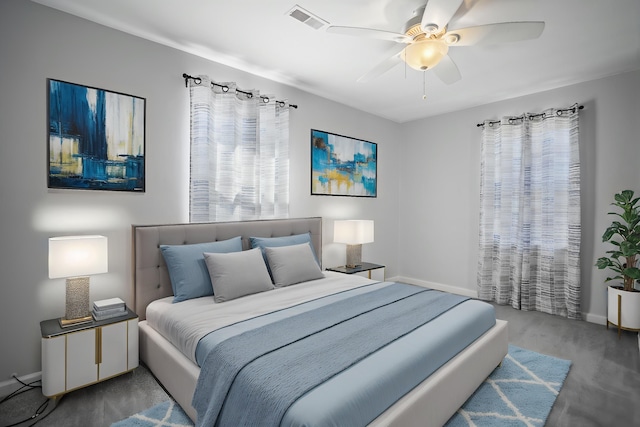 bedroom featuring baseboards, a ceiling fan, wood finished floors, and visible vents