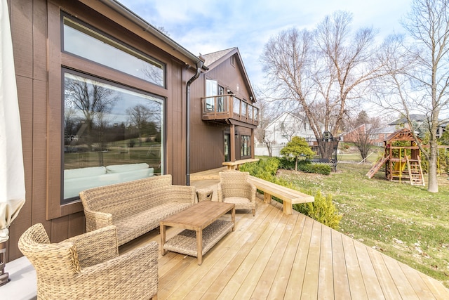 wooden deck featuring a lawn and a playground