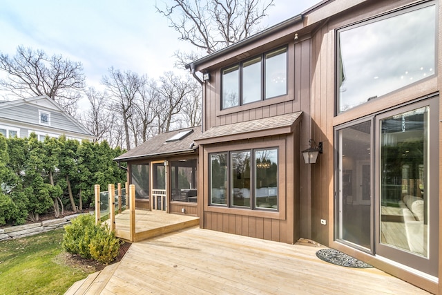 wooden deck featuring a sunroom