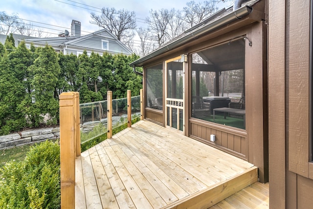wooden deck featuring a sunroom