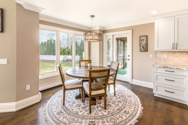 dining area featuring a baseboard radiator, a chandelier, baseboards, ornamental molding, and dark wood finished floors