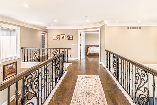 hall with recessed lighting, an upstairs landing, visible vents, and wood finished floors