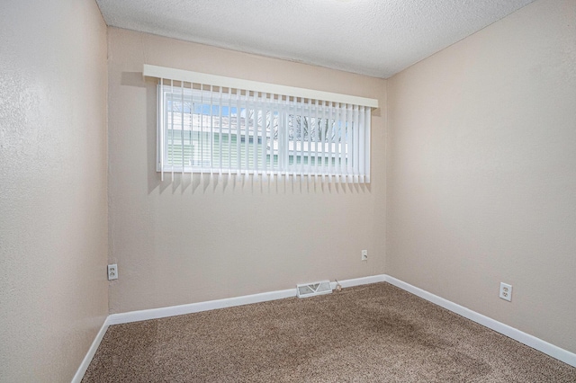 unfurnished room featuring visible vents, baseboards, and carpet flooring