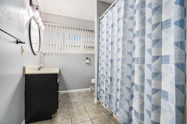 full bathroom featuring a shower with shower curtain, vanity, baseboards, tile patterned flooring, and a textured ceiling