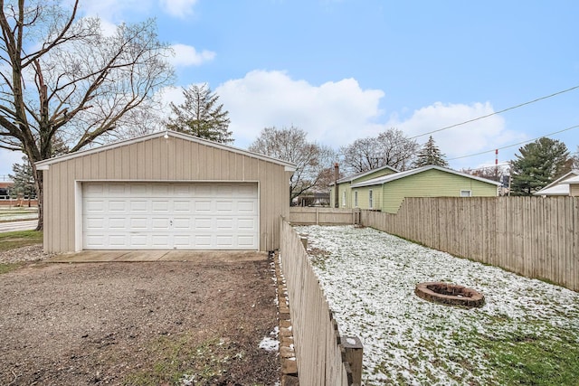detached garage featuring fence