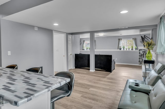 living area featuring visible vents, recessed lighting, light wood-style floors, and baseboards