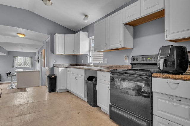 kitchen with lofted ceiling, electric range, white cabinetry, and a sink