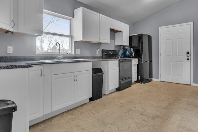 kitchen with black appliances, dark countertops, white cabinetry, and a sink