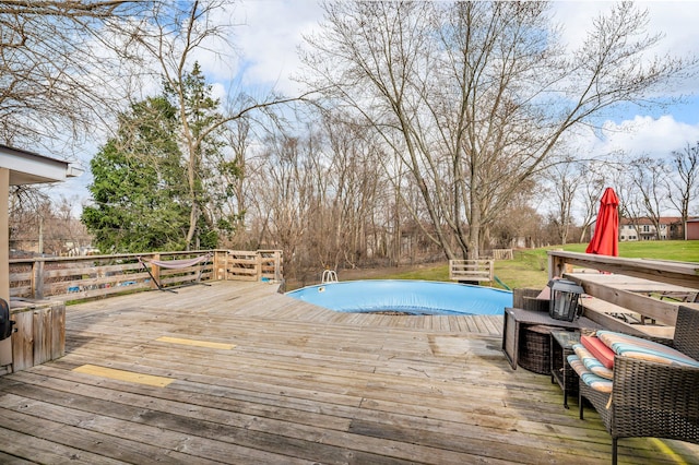 view of swimming pool with a deck
