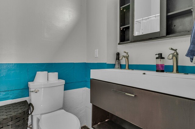 full bathroom with toilet and vanity