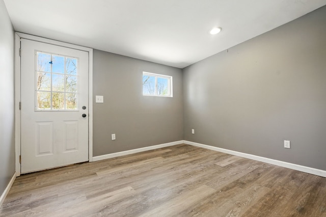 entryway featuring baseboards and light wood finished floors