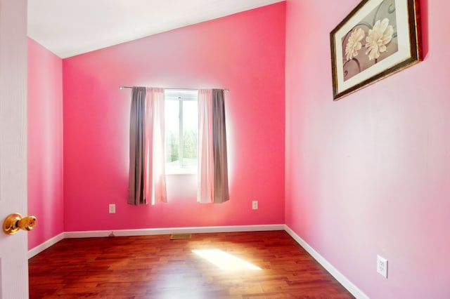 unfurnished room featuring visible vents, wood finished floors, and baseboards