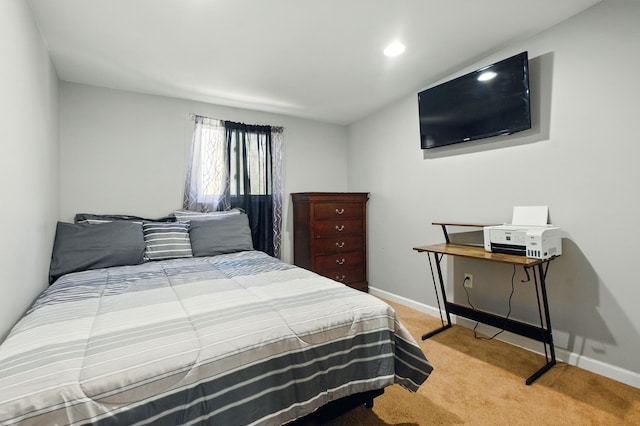 bedroom featuring baseboards and light carpet