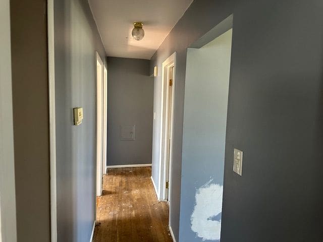 corridor featuring wood-type flooring