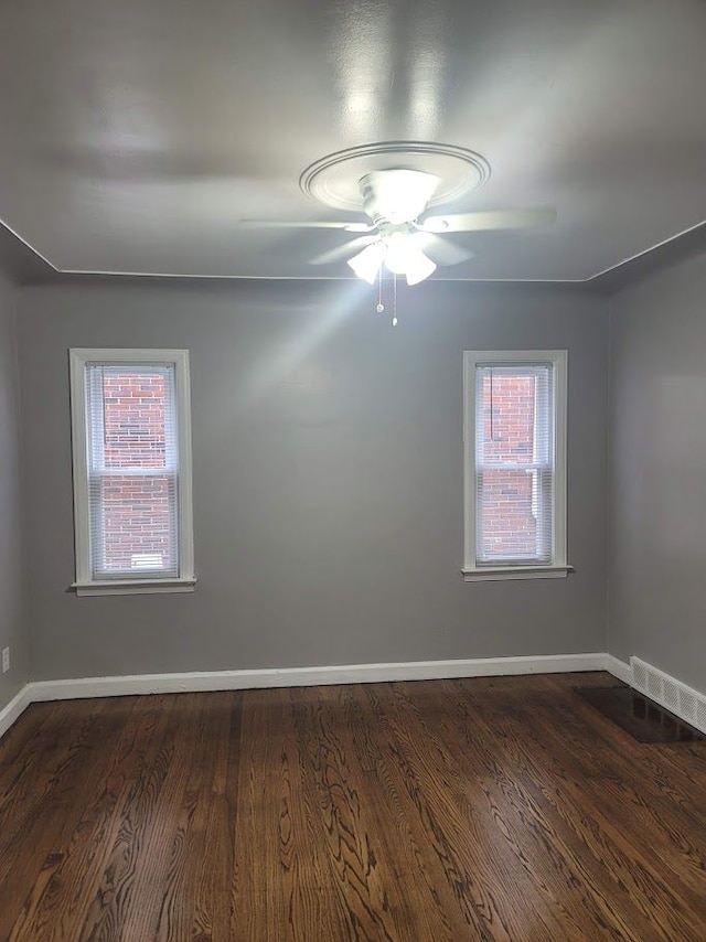 18639 Appoline St, Detroit, MI 48235 - empty room with plenty of natural light, baseboards, dark wood finished floors, and ceiling fan